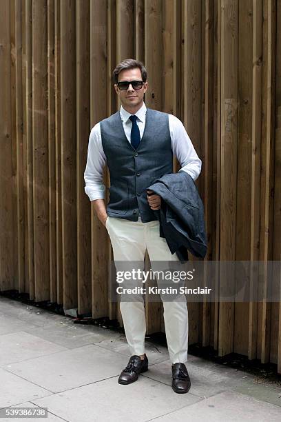 Model and TV Presenter for Britan's Next Top Model Paul Sculfor wears a Private White jacket, shirt, trousers and waistcoat, Patrick Cox shoes,...