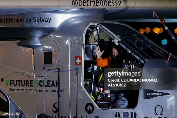 Swiss pilot Andre Borschberg waves to the crowd after the Solar Impulse 2 aircraft successfully landed at JFK International Airport on June 11, 2016...