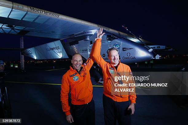 Swiss pilot Andre Borschberg and Swiss pilot Bertrand Piccard celebrate after successfully landing the Solar Impulse 2 aircraft at JFK International...