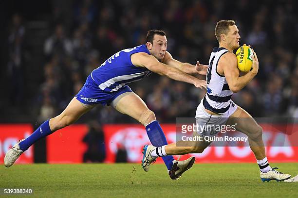 Joel Selwood of the Cats is tackled by Todd Goldstein of the Kangaroos during the round 12 AFL match between the Geelong Cats and the North Melbourne...