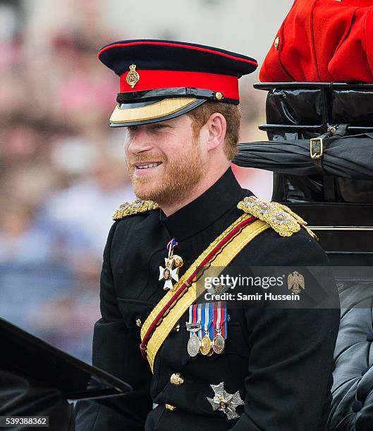 Prince Harry rides by carriage during the Trooping the Colour, this year marking the Queen's official 90th birthday at The Mall on June 11, 2016 in...