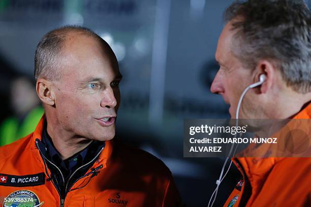 Swiss pilot Bertrand Piccard speaks with Swiss pilot Andre Borschberg after the successful landing of the Solar Impulse 2 aircraft at JFK...