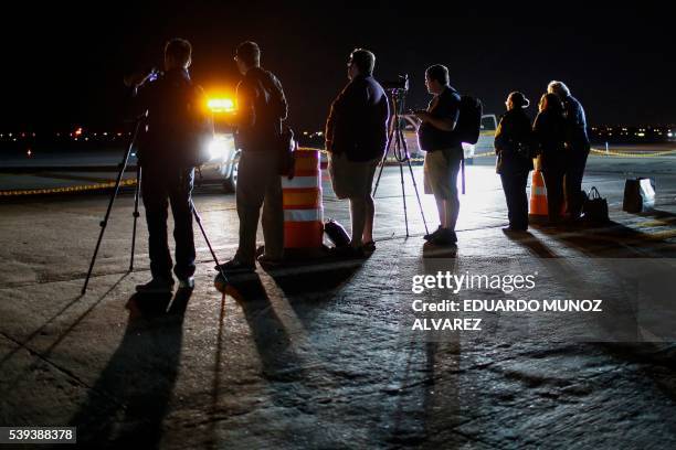 Journalists await the arrival of the Solar Impulse 2 aircraft at JFK International Airport on June 11, 2016 in Queens, New York. - Solar Impulse 2...