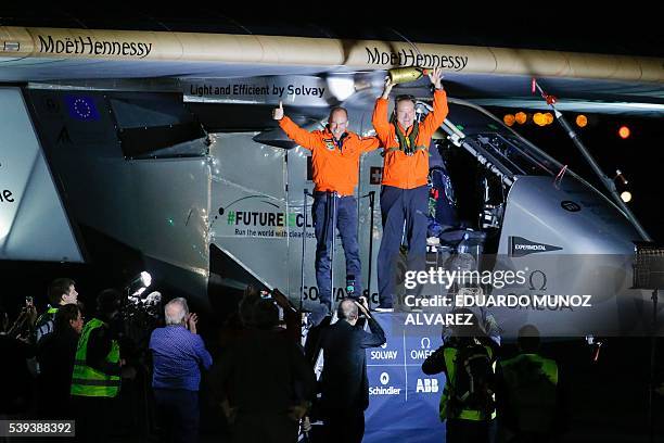 Swiss pilot Andre Borschberg and Swiss pilot Bertrand Piccard celebrate after the successful landing of the Solar Impulse 2 aircraft at JFK...