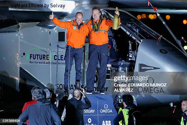 Swiss pilot Andre Borschberg and Swiss pilot Bertrand Piccard celebrate after the successful landing of the Solar Impulse 2 aircraft at JFK...