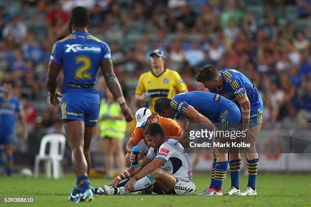 William Zillman of the Titans receives attention from the trainer during the round 14 NRL match between the Parramatta Eels and the Gold Coast Titans...