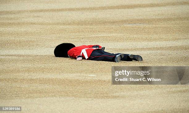 Member of the Queens Guard collapses during the Trooping the Colour, this year marking the Queen's 90th birthday at The Mall on June 11, 2016 in...