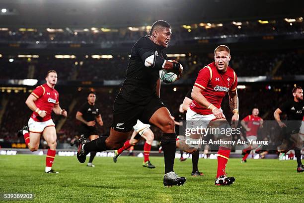 Waisake Naholo of New Zealand makes a break against Ross Moriarty of Wales during the International Test match between the New Zealand All Blacks and...