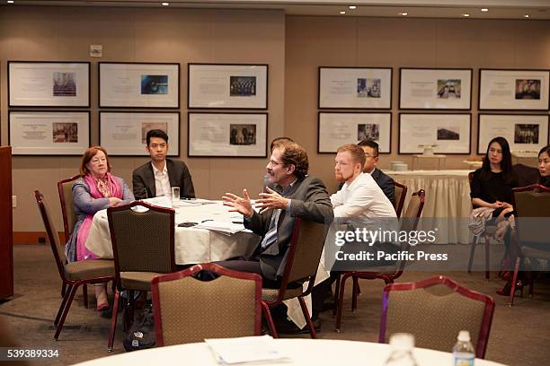 Attendee asks questions as Mary Wadsworth Darby (l) Alan..., News Photo
