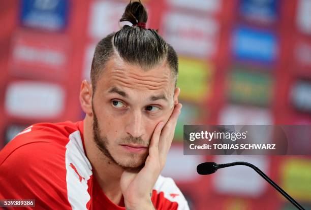 Austria's forward Marko Arnautovic holds a press conference at the Austrian team's training ground in Mallemort, southern France, on June 11 during...