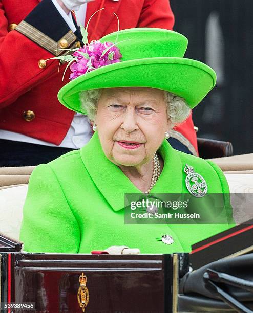 Queen Elizabeth II rides by carriage during the Trooping the Colour, this year marking the Queen's official 90th birthday at The Mall on June 11,...