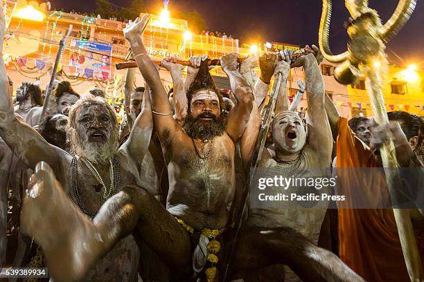 Group of Holy Hindu Monks is cheering with strong dreadlocks after taking the holy dip early morning on the bank of sacred river Shipra, also known...