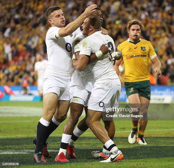 Jonathan Joseph of England is mobbed by team mates after scoring their first try during the International Test match between the Australian Wallabies...