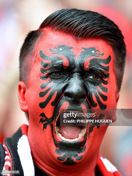 An Albania supporter cheers for his team ahead of the Euro 2016 group A football match between Albania and Switzerland at the Bollaert-Delelis...