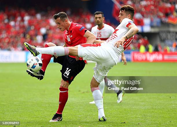 Taulant Xhaka of Albania and Granit Xhaka of Switzerland compete for the ball during the UEFA EURO 2016 Group A match between Albania and Switzerland...