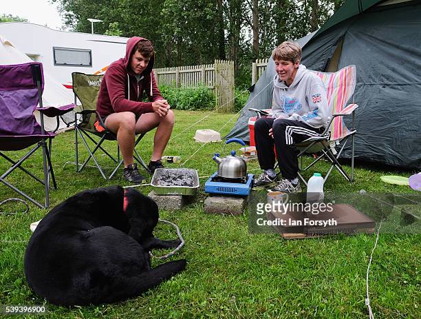 After camping out by the river, people have food while they wait to watch rowers from across the country take part in the 183rd annual regatta on the...