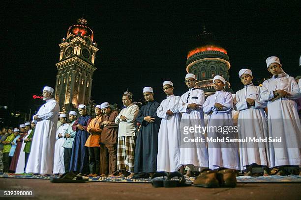 Muslims perform a special prayer called "taraweeh" in front of Sultan Abdul Samad building at Independent Square during the holy month of Ramadan on...