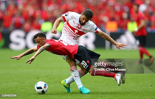 Ergys Kace of Albania and Ricardo Rodriguez of Switzerland compete for the ball during the UEFA EURO 2016 Group A match between Albania and...