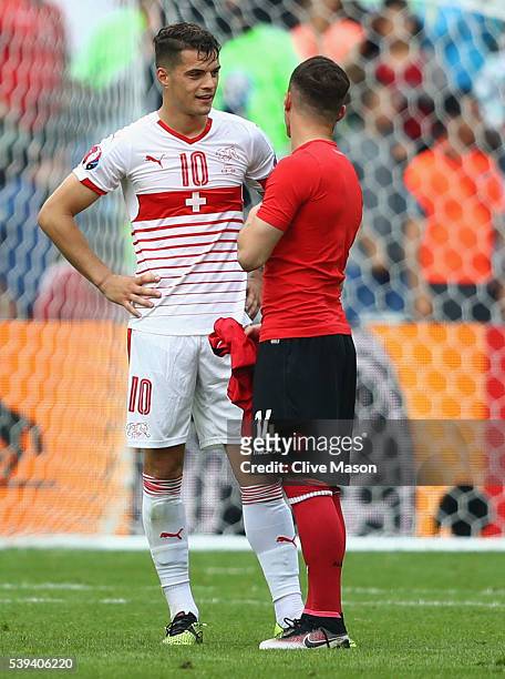 Granit Xhaka of Switzerland and Taulant Xhaka of Albania swap shirts after the UEFA EURO 2016 Group A match between Albania and Switzerland at Stade...