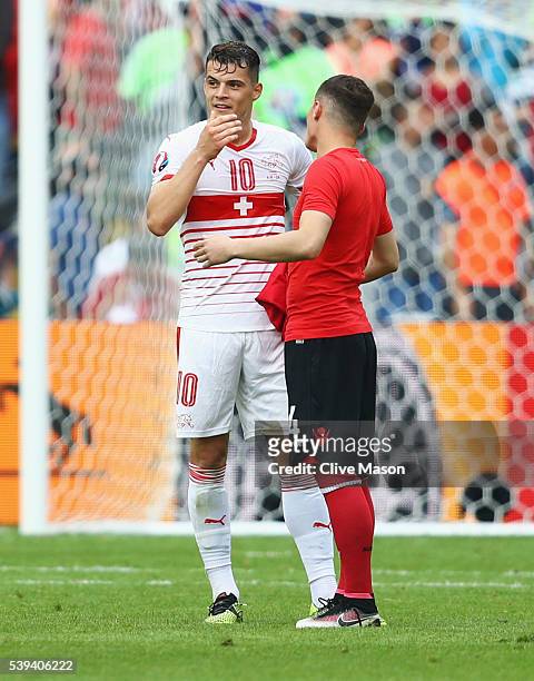 Granit Xhaka of Switzerland and Taulant Xhaka of Albania swap shirts after the UEFA EURO 2016 Group A match between Albania and Switzerland at Stade...