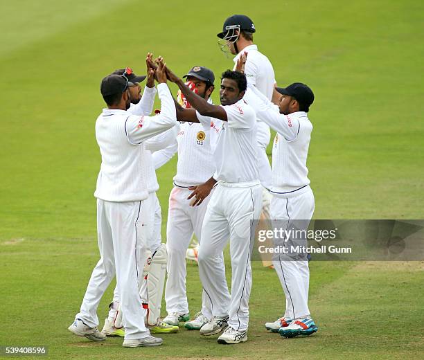 Nick Compton of England walks off after being dismissed as Shaminda Eranga of Sri Lanka celebrates the wicket during day three of the 3rd Investec...