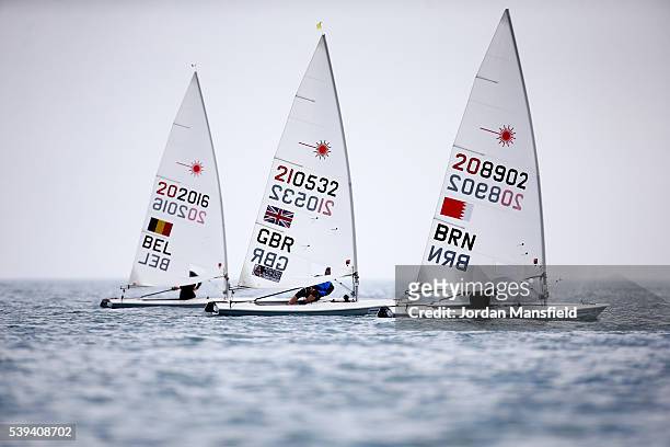 Abdulla Janahi of Bahrain, Jack Aitken of Great Britain and Wannes van Laer of Belgium compete in the Laser during day six of the ISAF Sailing World...