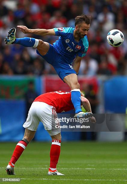 Dusan Svento of Slovakia and Jonathan Williams of Wales compete for the ball during the UEFA EURO 2016 Group B match between Wales and Slovakia at...