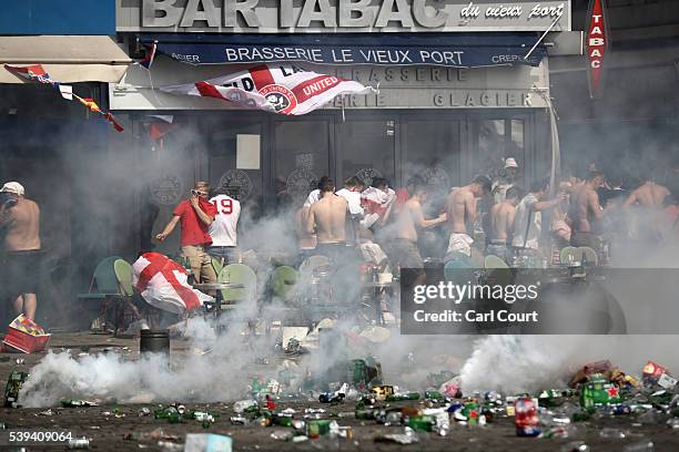 England fans react after police sprayed tear gas during clashes ahead of the game against Russia later today on June 11, 2016 in Marseille, France....