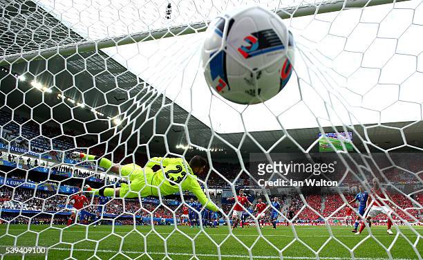 Matus Kozacik of Slovakia dives in vain as Gareth Bale of Wales scores his team's first goal during the UEFA EURO 2016 Group B match between Wales...