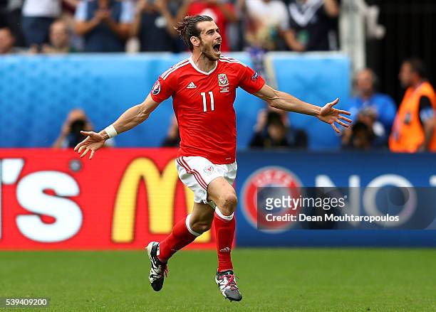 Gareth Bale of Wales celebrates scoring his team's first goal during the UEFA EURO 2016 Group B match between Wales and Slovakia at Stade Matmut...