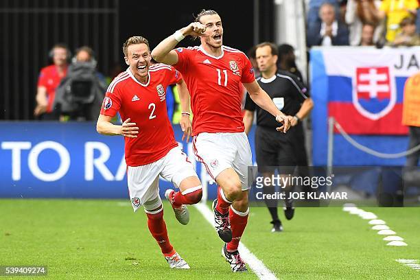 Wales' forward Gareth Bale celebrates after scoring the first goal during the Euro 2016 group B football match between Wales and Slovakia at the...