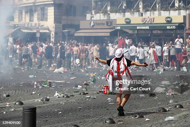 Fan wears the Englad flag colors as rubbish lines the streets as England fans gather, cheer and clash with police ahead of the game against Russia...