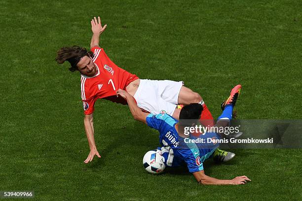 Michal Duris of Slovakia and Joe Allen of Wales compete for the ball during the UEFA EURO 2016 Group B match between Wales and Slovakia at Stade...