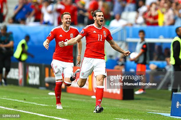 Gareth Bale of Wales celebrates after scoring a goal during Group-B preliminary round between Wales and Slovakia at Stade Matmut Atlantique on June...