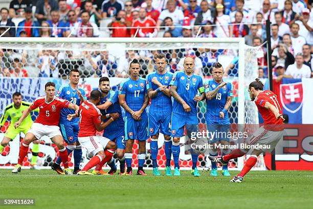 Gareth Bale of Wales kicks the ball to score a goal during Group-B preliminary round between Wales and Slovakia at Stade Matmut Atlantique on June...