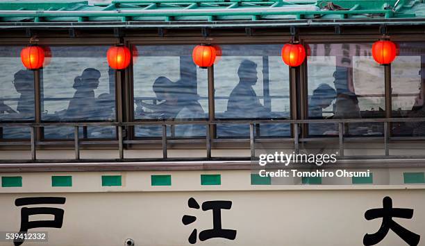 Customers ride on a yakatabune, or traditional low barge style boat as it sails through Tokyo Bay on June 11, 2016 in Tokyo, Japan. About 35...