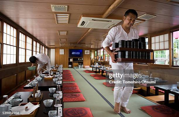 Employees prepare before a yakatabune, or traditional low barge style boat, operated by Mikawaya shipping agent, departs the pier on June 11, 2016 in...