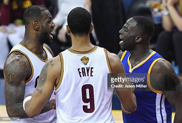 LeBron James of the Cleveland Cavaliers exchanges words with Draymond Green of the Golden State Warriors during the second half in Game 4 of the 2016...
