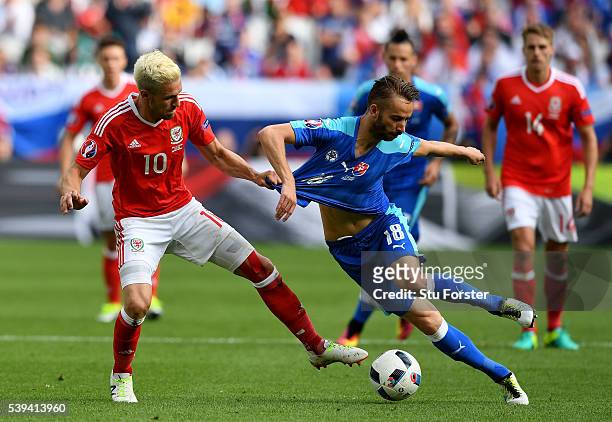 Dusan Svento of Slovakia and Aaron Ramsey of Wales compete for the ball during the UEFA EURO 2016 Group B match between Wales and Slovakia at Stade...