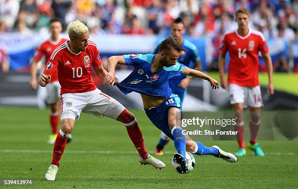 Dusan Svento of Slovakia and Aaron Ramsey of Wales compete for the ball during the UEFA EURO 2016 Group B match between Wales and Slovakia at Stade...