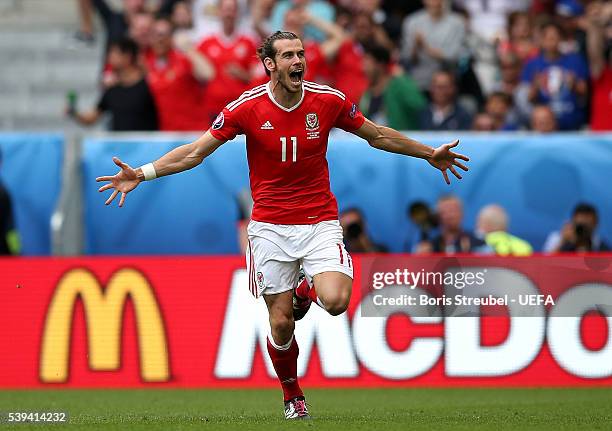 Gareth Bale of Wales celebrates scoring his team's first goal during the UEFA EURO 2016 Group B match between Wales and Slovakia at Stade Matmut...