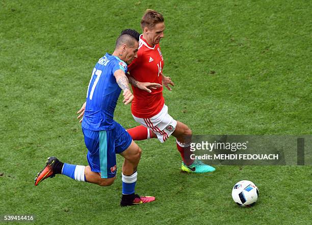 Slovakia's midfielder Marek Hamsik vis for the ball against Wales' midfielder David Edwards during the Euro 2016 group B football match between Wales...