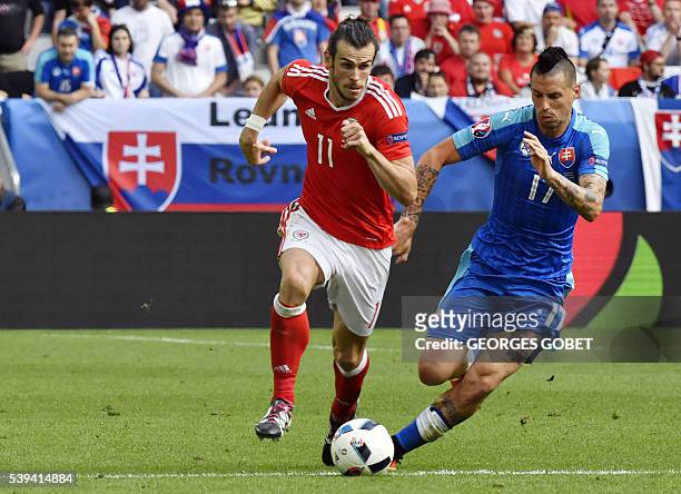 Wales' forward Gareth Bale vies for the ball against Slovakia's midfielder Marek Hamsik during the Euro 2016 group B football match between Wales and...