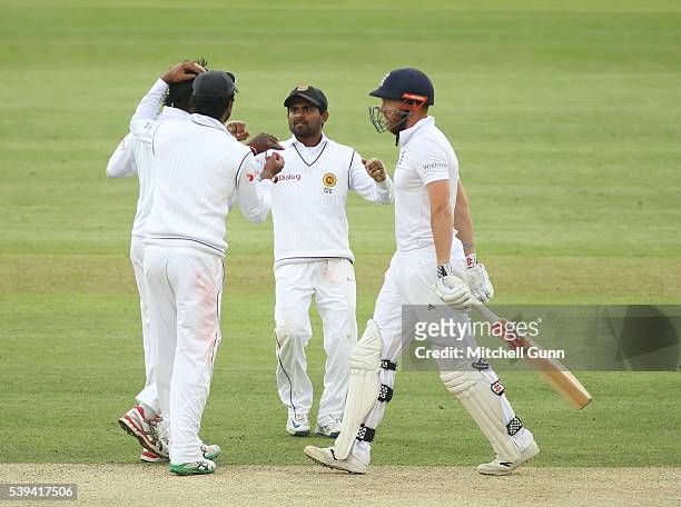 Jonny Bairstow of England walks off after being dismissed as Nuwan Pradeep of Sri Lanka celebrates during day three of the 3rd Investec Test match...
