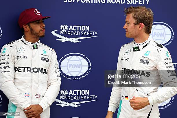 Lewis Hamilton of Great Britain and Mercedes GP and Nico Rosberg of Germany and Mercedes GP talk in parc ferme during qualifying for the Canadian...