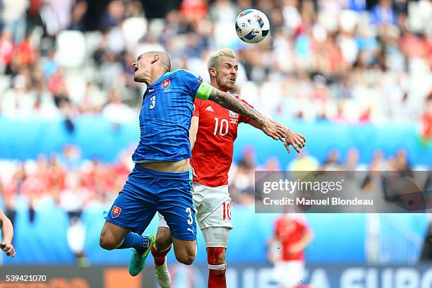 Aaron Ramsey of Wales duels for the ball with Martin Skrtel of Slovakia during Group-B preliminary round between Wales and Slovakia at Stade Matmut...