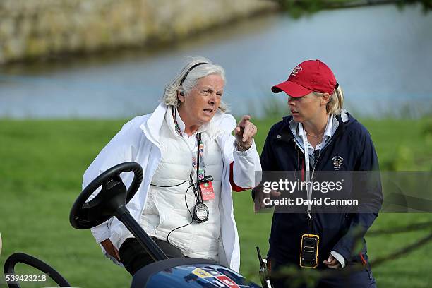 Gillian Kirkwood of Scotland the chief rules official talks with Liz Carl the United States team manager on the 14th tee during the afternoon...