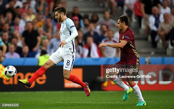 Adam Lallana of England controls the ball under pressure of Georgi Schennikov of Russia during the UEFA EURO 2016 Group B match between England and...