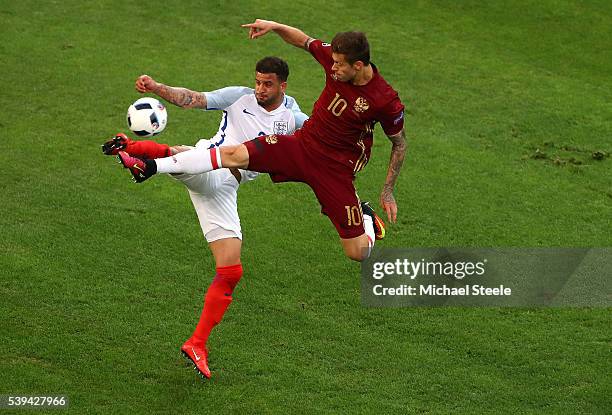 Kyle Walker of England and Fedor Smolov of Russia compete for the ball during the UEFA EURO 2016 Group B match between England and Russia at Stade...