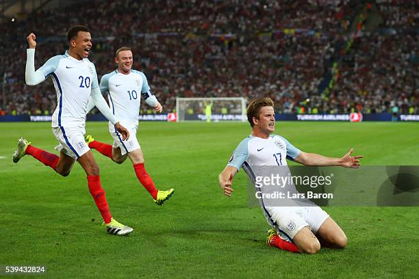 Eric Dier of England celebrates scoring his team's first goal with his team mates Dele Alli and Wayne Rooney during the UEFA EURO 2016 Group B match...